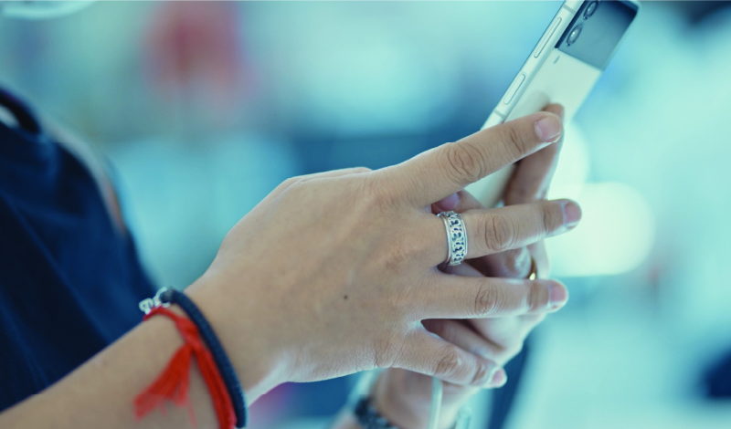 Woman's hands holding a cell phone